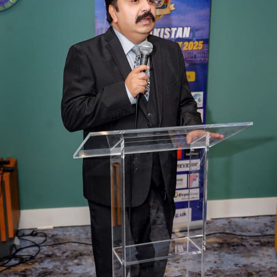 A speaker addressing the summit from the podium