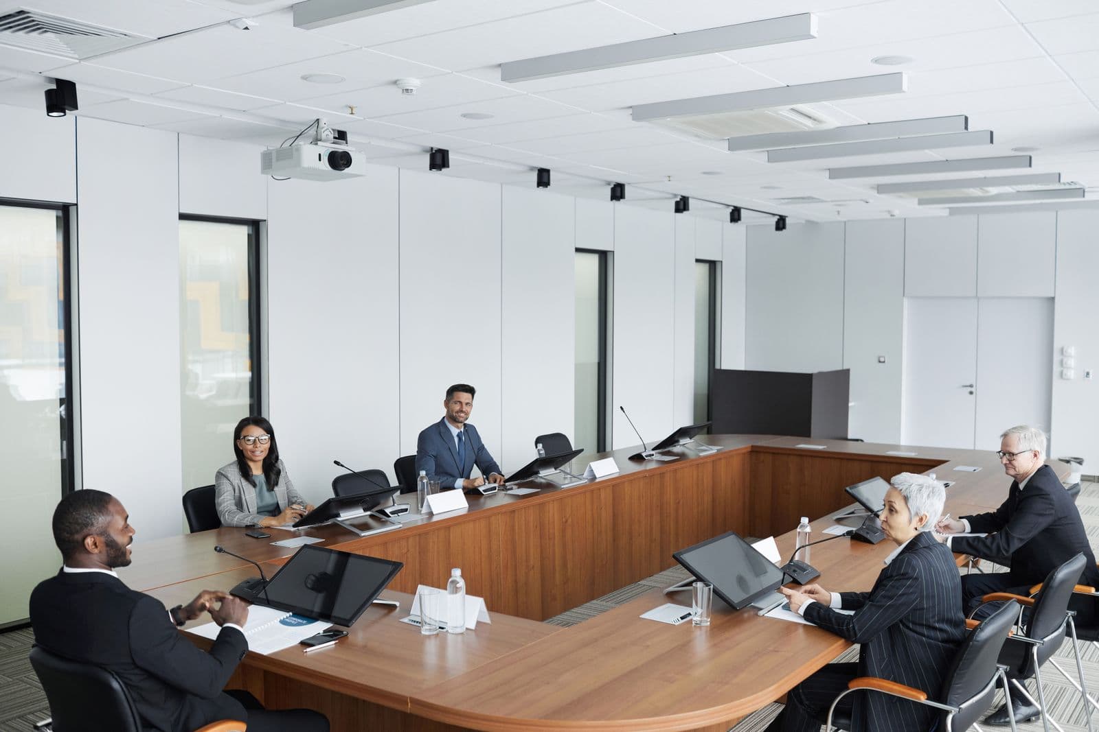 Executives seated around a boardroom table