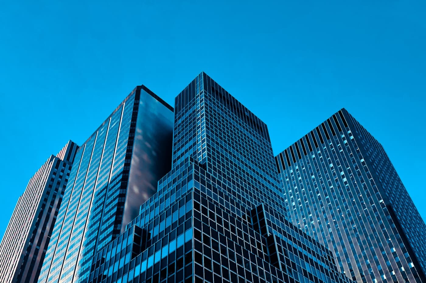 Glass office towers in a financial district seen from street level
